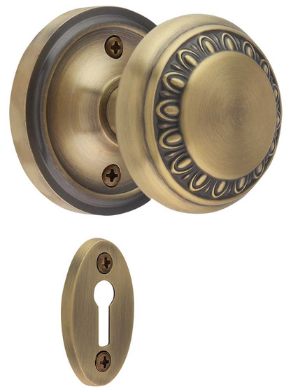 Classic Rosette Mortise-Lock Set with Ovolo Knobs in Antique Brass.